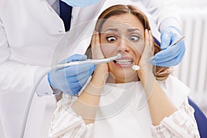 Afraid woman at dentist office