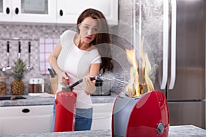 An Afraid Woman Extinguishing Burning Red Toaster