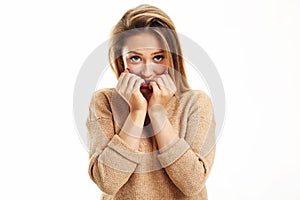 Afraid woman looking at camera on a white background