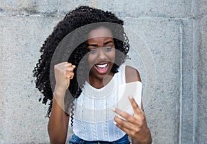 Africa american woman receiving good news on phone