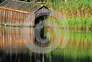 Africa- Beautifully Reflected Boat House on a River