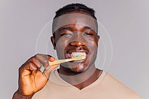 africa man toothbrush in gray background isolate