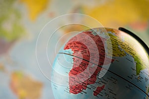 Africa map on a globe with earth map in the background.