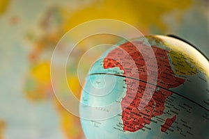 Africa map on a globe with earth map in the background.
