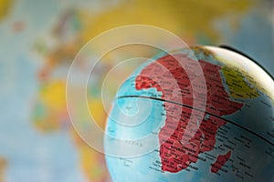 Africa map on a globe with earth map in the background.