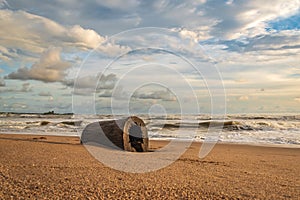 Africa`s gold coast with a hollow log on the beach