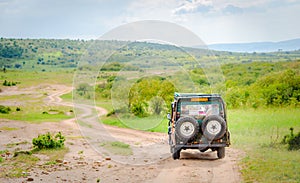 Africa safari jeep driving on Masai Mara and Serengeti national park