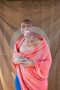 African adult woman smiling wrapped in red fabric