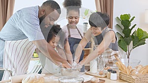 African America family wearing apron thresh flour for cooking bakery or bread together in the kitchen at home.