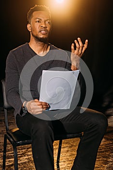 African american actor holding scenario on