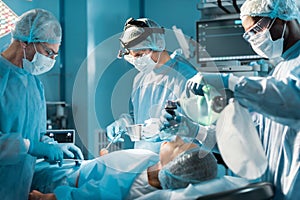 african american anesthetist holding oxygen mask above patient