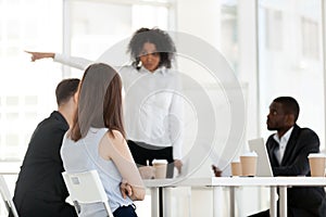 African American angry boss point at door, ask employee leave