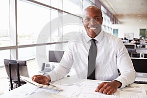 African American architect at work, smiling to camera