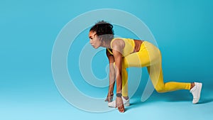 African American Athlete Woman Doing Crouch Start Over Blue Background