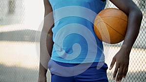African American basketball player holding ball, preparing for game, sport