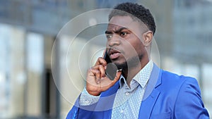 African American bearded man calls to colleague on phone