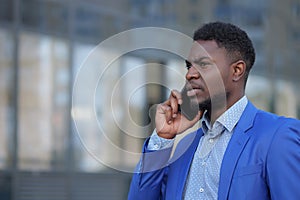 African American bearded man calls to colleague on phone