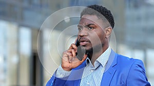 African American bearded man calls to colleague on phone