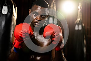 African American Black boxer wearing red glove in defensive guard. Impetus