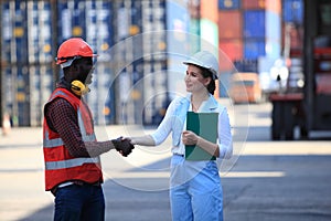 African American  black engineer and businesswoman they are working in container box yard area of  logistics transportation import