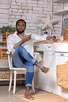 African American black man cooking breakfast or lunch on kitchen at home. Healthy food concept.