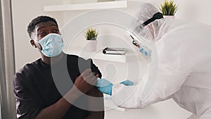 African american black man with face mask receiving vaccine against covid19