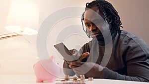 African american black man making online purchase using credit card and smartphone app