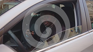 African american black man showing car key and thumb up while sitting in his new car
