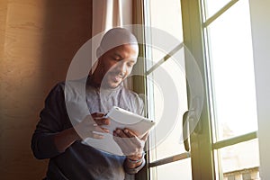 African american black man using electronic tablet at home