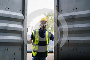 African-American black workers are opening containers for inspection and check that repairs have been completed in containers