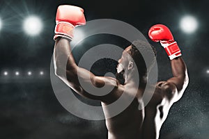 African american boxing champion raising hands up photo