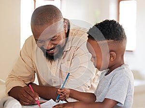 African american boy doing homework with his dad. A handsome black man helping his son with school work at home. Its