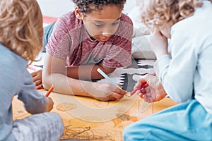 African-american boy drawing with classmate photo