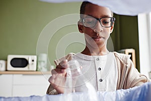 African American Boy Recycling Plastic Bottles