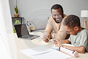 African American Boy Studying with Father at Home