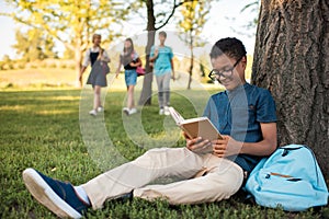 African american boy studying in park