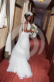 African american bride smiling at the camera holding bouquet