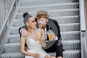 african american bride smiling near redhead