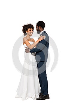African american bridegroom and bride hugging isolated on white