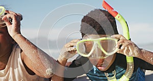 African american brother and sister wearing scuba diving mask with a snorkel at the beach