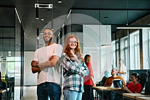 An African-American business colleague and his orange-haired female counterpart engage in collaborative discussion