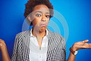 African american business executive woman over  blue background clueless and confused expression with arms and hands