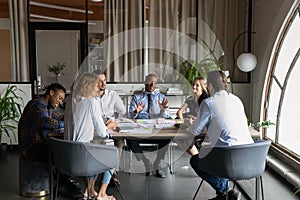 African American business leader talking to team of employees