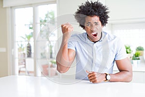 African American business man angry and mad raising fist frustrated and furious while shouting with anger