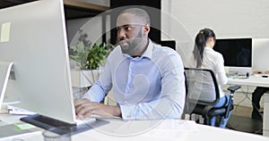African American business man manager working on computer with businesspeople team in modern creative office