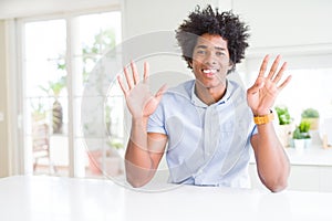 African American business man showing and pointing up with fingers number nine while smiling confident and happy