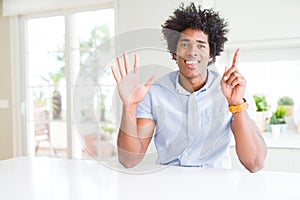 African American business man showing and pointing up with fingers number six while smiling confident and happy