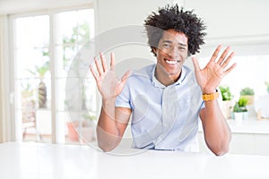 African American business man showing and pointing up with fingers number ten while smiling confident and happy