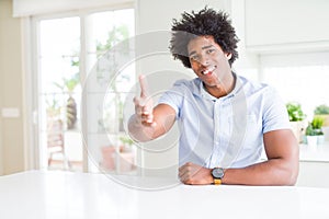 African American business man smiling friendly offering handshake as greeting and welcoming