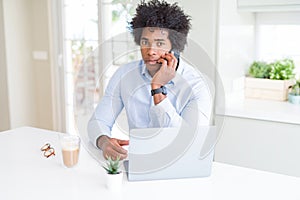 African American business man talking on the phone with a confident expression on smart face thinking serious